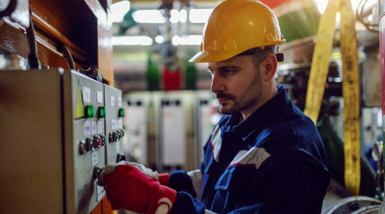 Technician in front of a control panel